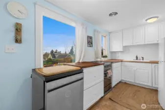 Here's the updated kitchen with subway tile and butcher block countertops.  All appliances convey with the home.
