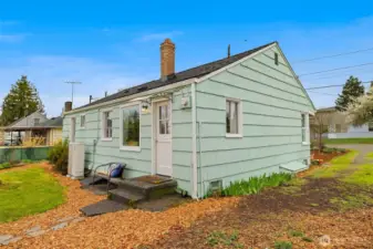 Back view of the home.  Notice the heat pump system for high efficiency heating and cooling.