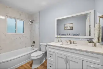 The main floor bath is spacious and bright with a large vanity and plenty of storage.