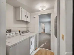 The conveniently located laundry area sits just inside the back door, offering easy access and functionality. This practical space is perfect for handling daily chores while keeping everything organized and within reach.