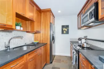 Updated Galley Kitchen with custom cabinets, stainless steel appliances and custom Miele dishwasher.