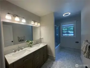 Main Level Bathroom with Marble Countertop and Floors