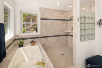 Massive tiled shower and soaking tub look out over your private backyard.