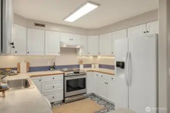 Bright and light kitchen with white cabinetry.