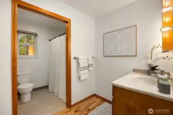 Primary bath features separate sink and toilet/shower areas.