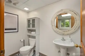 In the laundry area off the garage features a powder room