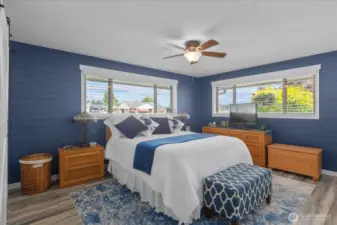 Spacious owner’s suite with dual windows for natural light * Rich navy shiplap accent wall