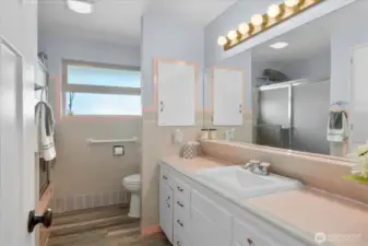 Charming vintage-style main bathroom with iconic pink &   gray tile countertop with matching trim