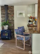 Wood fireplace with stone wall and eating area