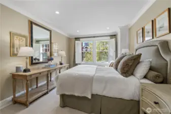 oversized primary bedroom, with beautiful sunny views over the courtyard, wood plantation shutters along with recessed lighting gives this home a modern yet classic vibe