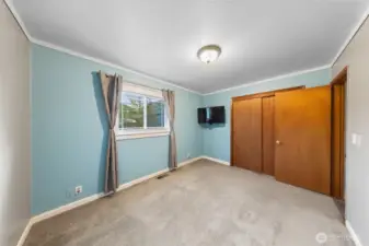 primary bedroom, hardwood floors beneath carpet
