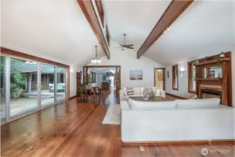 arge sliding glass doors provide seamless access to the outdoor living space, creating an effortless indoor-outdoor connection. Perfect for entertaining or relaxing, this transition invites natural light inside while offering easy access to the deck and surrounding private setting.