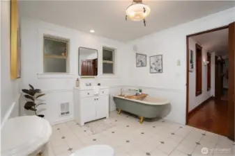 Charming, spa-inspired bathroom featuring a classic clawfoot soaking tub with elegant fixtures, creating a relaxing retreat. Bright and airy with abundant natural light, the space includes a clean vanity, timeless tile flooring, and tasteful finishes throughout. A perfect blend of character and comfort for everyday use or unwinding at the end of the day.