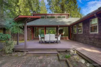 Surrounded by natural landscaping and connected to a charming brick patio, this private setting offers a seamless extension of the home’s living space in a peaceful backdrop.