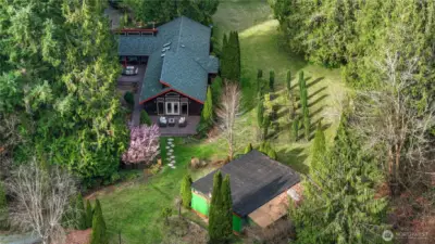 Charming Northwest-style home set on a beautifully manicured, park-like lot surrounded by mature evergreens. Expansive lawn and thoughtful landscaping create a peaceful, usable outdoor space perfect for relaxing or entertaining.