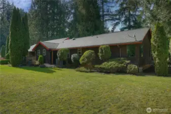 Charming Northwest-style home set on a beautifully manicured, park-like lot with mature evergreens and expansive usable lawn.