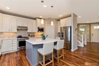 Lovely island with  Quartz Countertops and electrical plug in for heating food while entertaining!