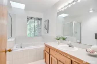 Primary bath 5-piece bathroom with jacuzzi tub.