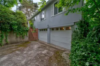 2 car garage with stairs to the entrance.