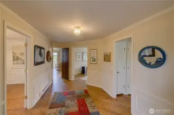 Main Entryway. Door to the left goes to the formal dining room, next door goes to the kitchen and dining room, center door is the main family room, door to the right goes down the hall to the bedrooms.