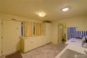 Lower level utility room with laundry. Main door goes outside, 2nd door goes into the downstairs bathroom.