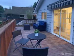 There are stairs down to the back yard and covered hot tub from the deck.