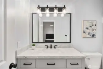 Updated primary bathroom with a huge vanity mirror.