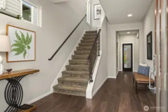 Warm luxury engineered hardwoods greet you at the expansive foyer.