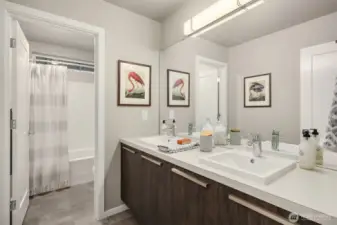 Full hall bath enjoys tile floors and double vanites.