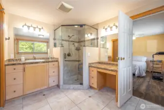Primary bath with large walk-in tile shower and 2 vanities.
