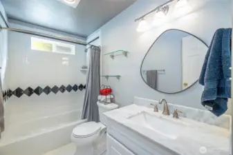 Wonderfully remodeled guest bathroom with tile floors.