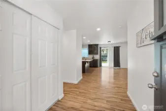 Front door entry. Coat closet on your left. And a 1/4 Bathroom around the corner to the left.