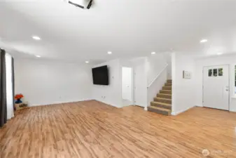 Laundry room and access to the garage through the door behind the TV.