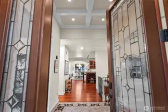 Grand foyer with coffered ceilings and hardwood floors, introducing the home’s timeless design and effortless main-floor living flow
