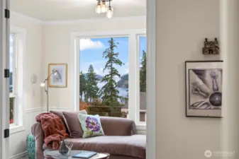 Light-filled office/sitting room with generous picture windows framing Puget Sound and evergreen views—an inviting retreat on the main level.  A dream work from home office.