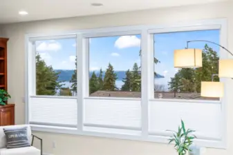 A wall of windows captures Puget Sound and treetop views, bringing the beauty of Gig Harbor into the heart of the home.