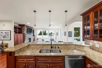 Gourmet kitchen vantage highlighting granite counters, pendant lighting, and seamless connection to the living area for effortless entertaining.