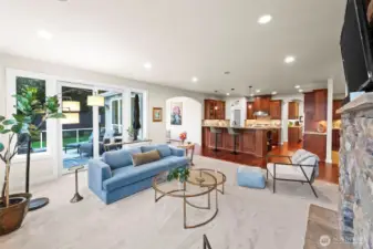 Great room to kitchen perspective, showcasing the home’s open architecture, indoor-outdoor living, and natural light.