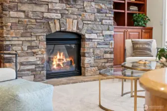 Cozy fireplace detail welcomes gatherings, adding warmth and character to the home’s central living space.