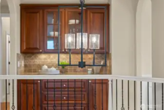 Designer lighting adds ambient glow to the main floor, complementing rich cabinetry and luxe finishes throughout.  The rich butlers pantry enhances the luxury look and also the abundant storage throughout the home.