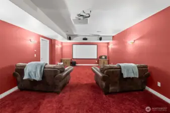 Dedicated home theater with projector, surround sound, and sound-treated walls.  All set for movie nights!