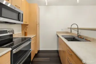 Nice kitchen with laminate wood flooring, nice cabinetry, and updated appliances!