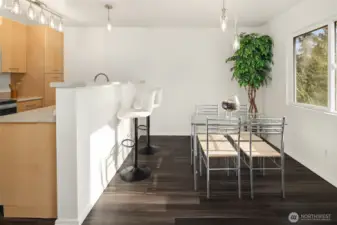 The dining area off the kitchen w/ window that looks out into the back lawn and trees