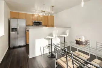 Open kitchen design, breakfast bar, and dining area