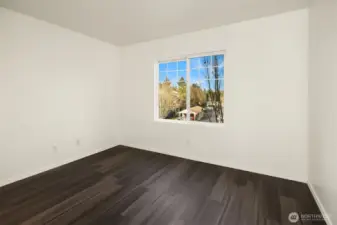 2nd bedroom with laminate wood flooring