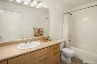 Hall bathroom with shower over the bath tub