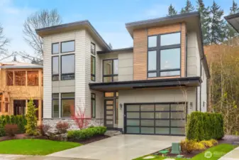 Soaring window walls on both sides of the home funnel natural light throughout the residence while open to territorial views. Front of the home looks out onto the community great lawn while the back faces the protected greenbelt and Tibbetts Creek