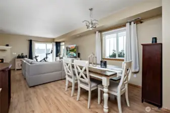 Dining area seamlessly connects to living room with balcony access.