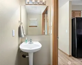 Half bathroom next to kitchen.