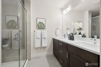 Primary bath with double sinks, quartz counters, and huge shower